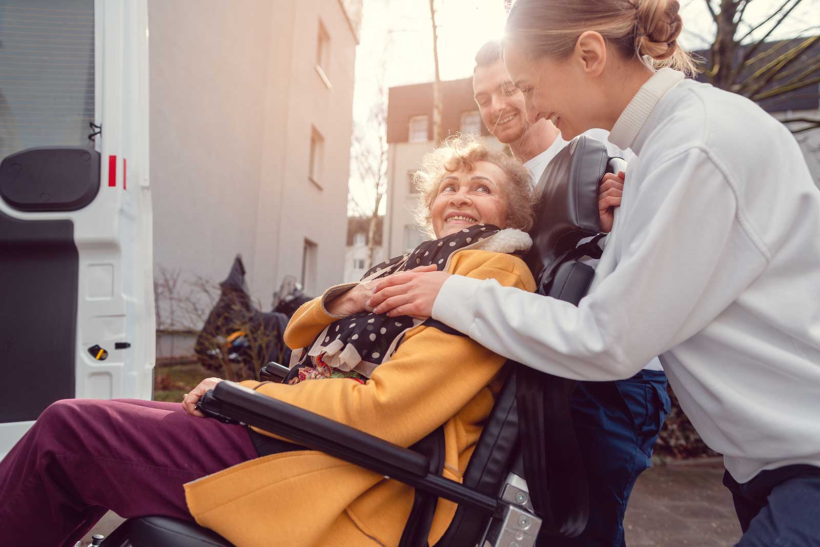 Woman in broda chair entering accessible van.